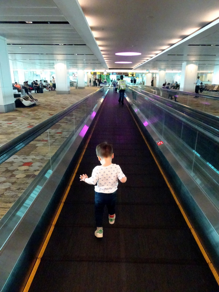 Max on the moving walkway at the Transfer Hall of Singapore Changi Airport