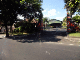 Gate and buildings at the Wage Rudolf Supratman street, viewed from the taxi from Nusa Dua to Gianyar