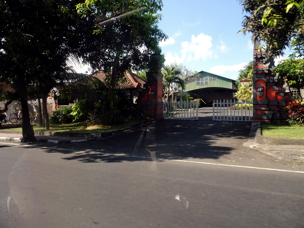 Gate and buildings at the Wage Rudolf Supratman street, viewed from the taxi from Nusa Dua to Gianyar