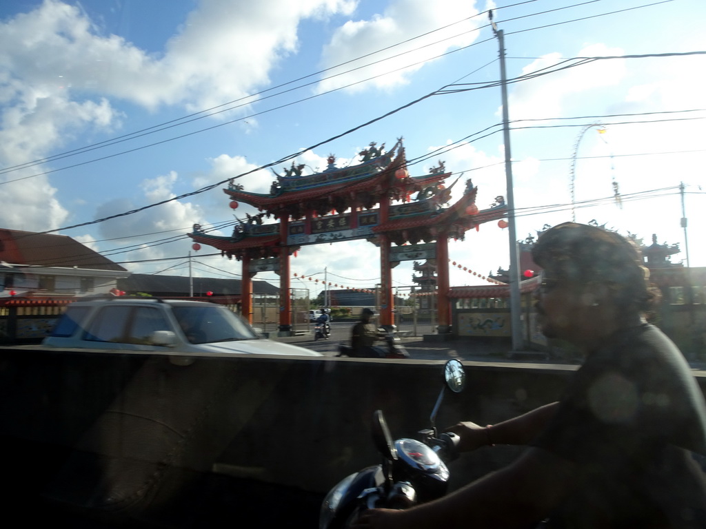 Entrance gate to the Satya Dharma Temple at the Jalan Raya Pelabuhan Benoa street, viewed from the taxi from Gianyar to Nusa Dua