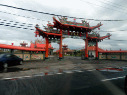Entrance gate to the Satya Dharma Temple at the Jalan Raya Pelabuhan Benoa street, viewed from the taxi from Nusa Dua to Ubud