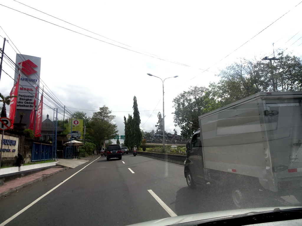 The Jalan By Pass Ngurah Rai street with the Patung Titi Banda statue, viewed from the taxi from Nusa Dua to Ubud
