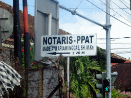 `Notaris` sign at the Jalan Raya Kuta street, viewed from the taxi from Beraban