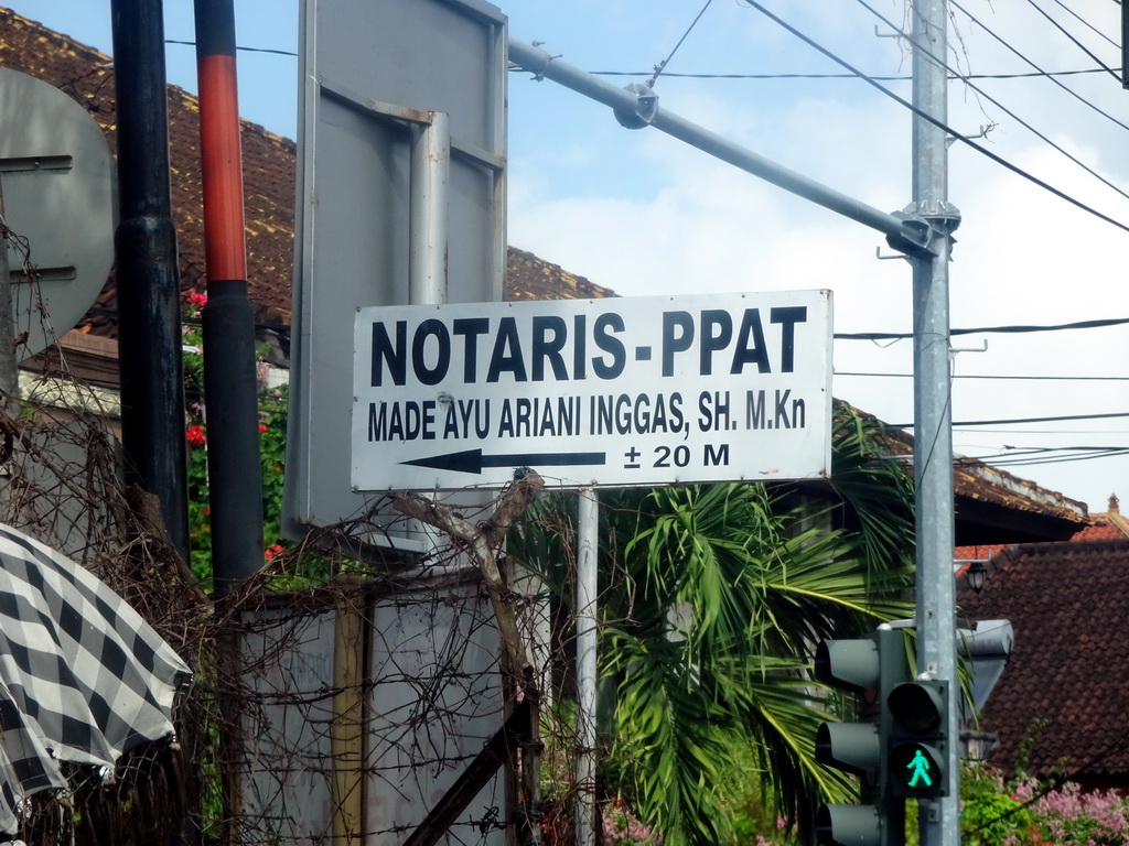 `Notaris` sign at the Jalan Raya Kuta street, viewed from the taxi from Beraban