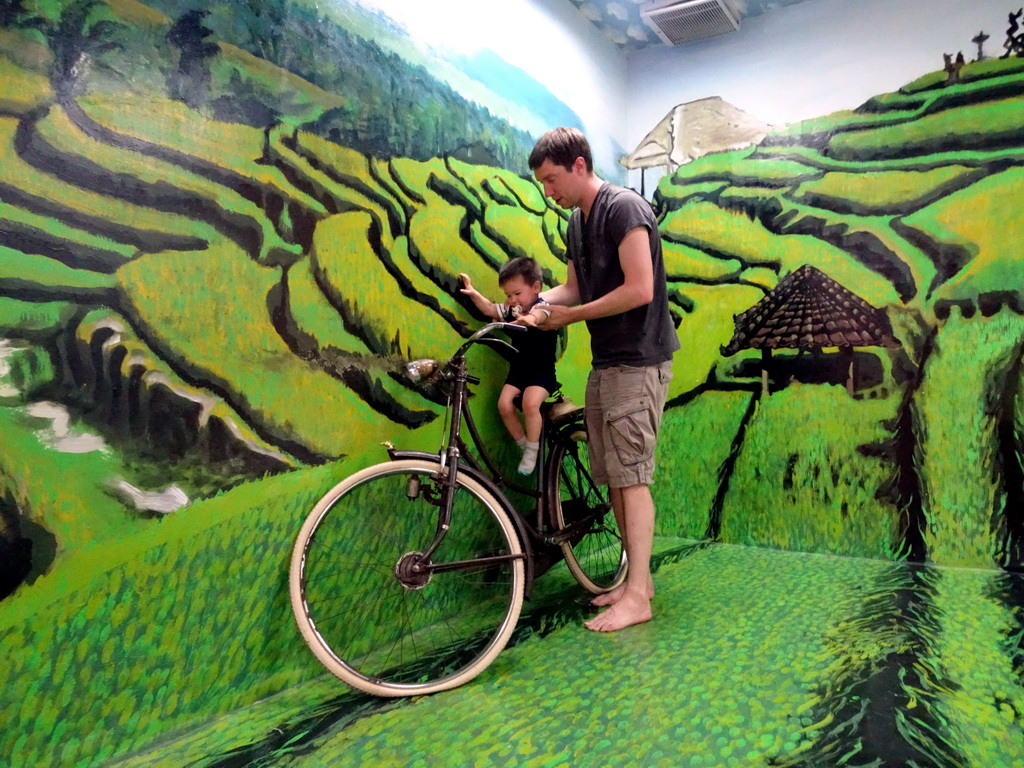 Tim and Max on a bike at a rice field at the Upside Down World Bali