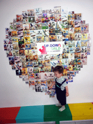 Max in front of the logo and photos of the Upside Down World Bali, at the lobby of the Upside Down World Bali at the Jalan By Pass Ngurah Rai street