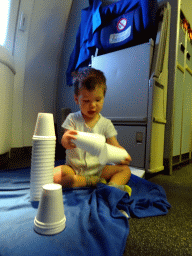 Max playing with plastic cups in the airplane from Singapore to Amsterdam