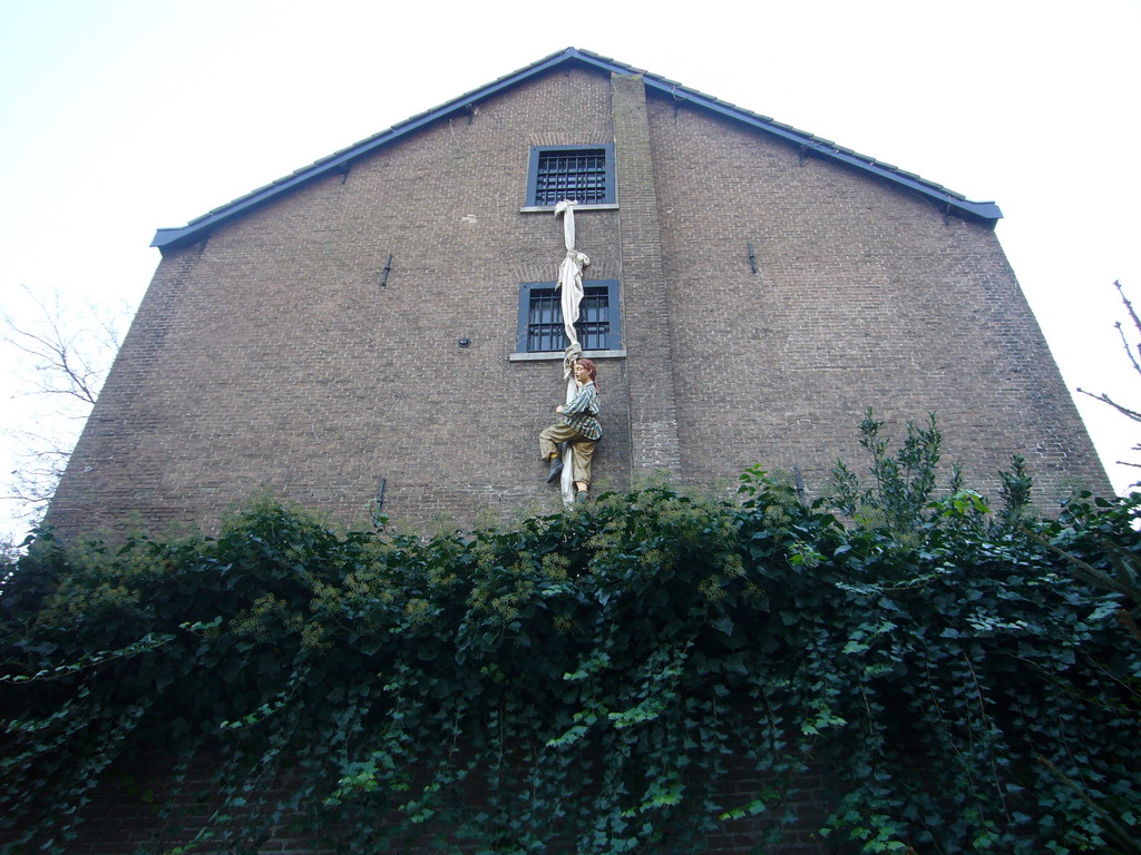 Statue hanging from a window at the Wallstreet Tea-Rose lunchroom at the Walstraat street