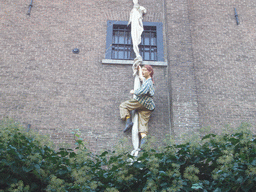Statue hanging from a window at the Wallstreet Tea-Rose lunchroom at the Walstraat street