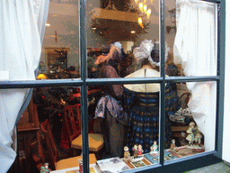 Actors in Victorian clothing in the window of a shop at the Walstraat street, during the Dickens Festival