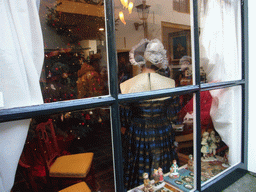 Actors in Victorian clothing in the window of a shop at the Walstraat street, during the Dickens Festival