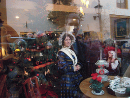 Actors in Victorian clothing in the window of a shop at the Walstraat street, during the Dickens Festival