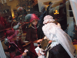 Actors in Victorian clothing in the window of a shop at the Walstraat street, during the Dickens Festival