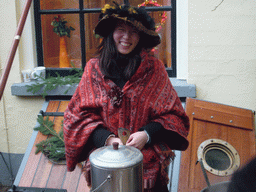 Miaomiao`s friend in Victorian clothing at a house at the Walstraat street, during the Dickens Festival