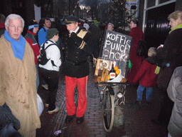 Actors in Victorian clothing singing at a square in the city center, during the Dickens Festival, at sunset