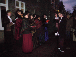 Actor in Victorian clothing at the Walstraat street, during the Dickens Festival, at sunset