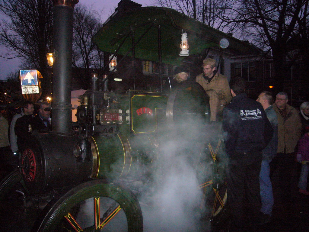 Old locomotive at the Bergkerkplein square, during the Dickens Festival parade, at sunset