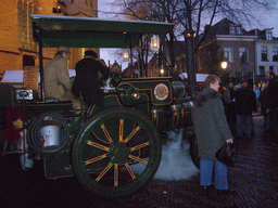 Old locomotive in front of the St. Nicholas Church at the Bergkerkplein square, during the Dickens Festival parade, at sunset