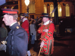 Actors in Victorian clothing in front of the St. Nicholas Church at the Bergkerkplein square, during the Dickens Festival parade, by night