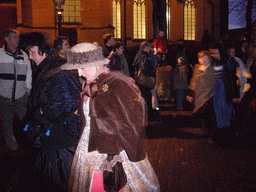 Actors in Victorian clothing in front of the St. Nicholas Church at the Bergkerkplein square, during the Dickens Festival parade, by night