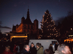 The south side of the Brink square with the front of the Waag building and a christmas tree, during the Dickens Festival parade, by night