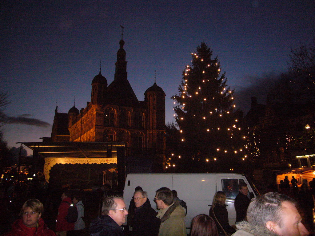 The south side of the Brink square with the front of the Waag building and a christmas tree, during the Dickens Festival parade, by night