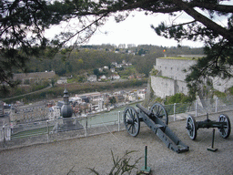 Cannons at the southeast part of the Citadel of Dinant, with a view on the city center with the tower of the Notre Dame de Dinant church and the Meuse river