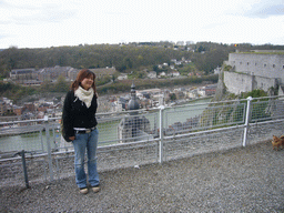 Miaomiao at the southeast part of the Citadel of Dinant, with a view on the city center with the tower of the Notre Dame de Dinant church and the Meuse river