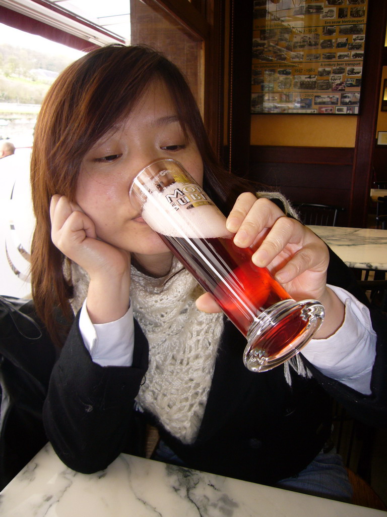 Miaomiao with a Mort Subite beer in a pub in the city center