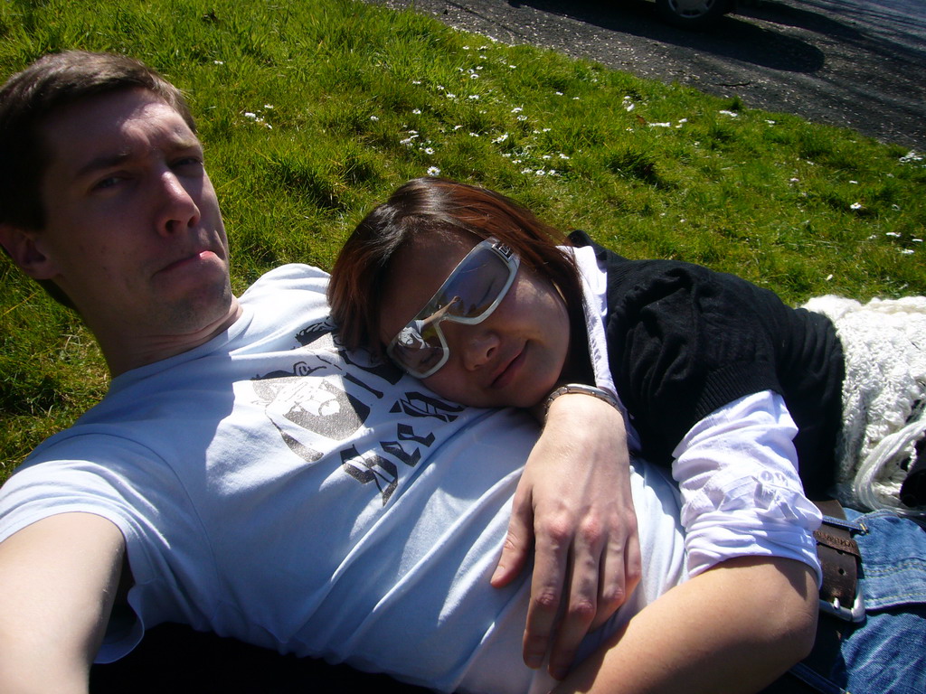 Tim and Miaomiao lying in the grass in front of the La Merveilleuse caves