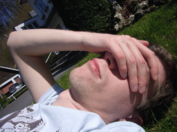 Tim lying in the grass in front of the La Merveilleuse caves