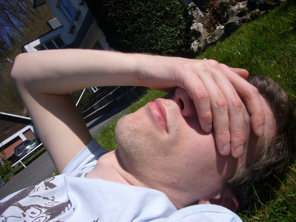 Tim lying in the grass in front of the La Merveilleuse caves