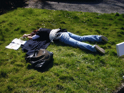 Miaomiao lying in the grass in front of the La Merveilleuse caves