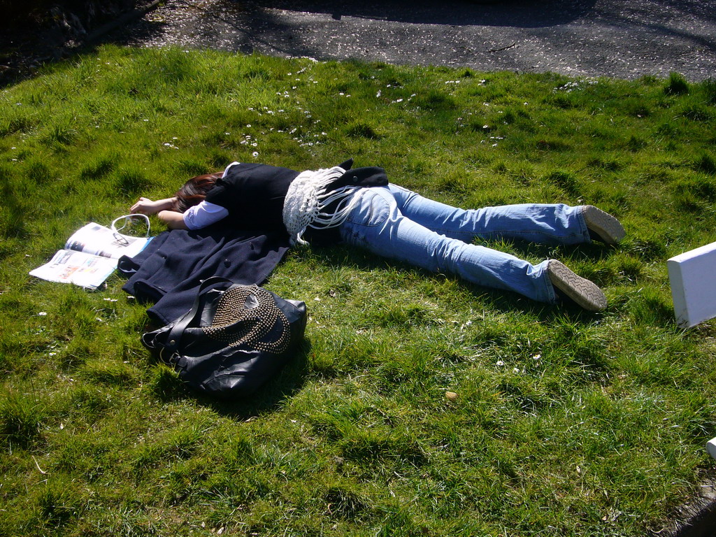 Miaomiao lying in the grass in front of the La Merveilleuse caves