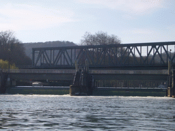 Sluice and railway bridge at the Île de Moniat island, viewed from the tour boat on the Meuse river