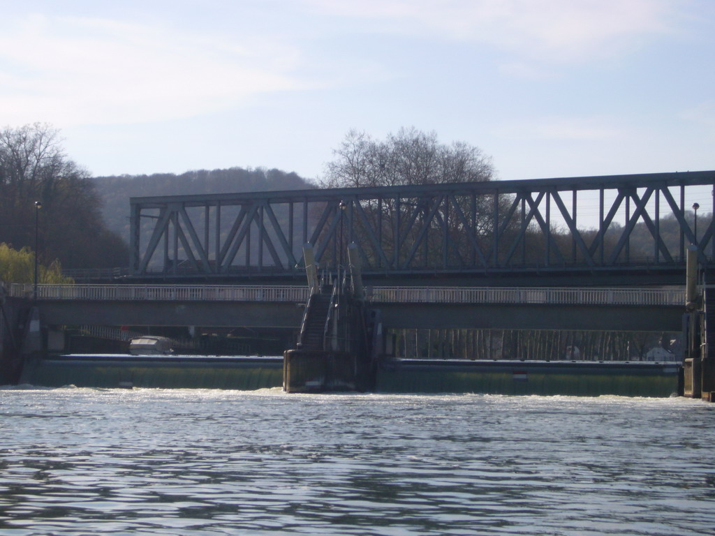 Sluice and railway bridge at the Île de Moniat island, viewed from the tour boat on the Meuse river