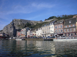 The city center with the Notre Dame de Dinant church, the Citadel of Dinant and the Pont Charles de Gaulle bridge over the Meuse river, viewed from the tour boat