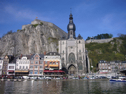 The city center with the Notre Dame de Dinant church, the Citadel of Dinant and the Meuse river, viewed from the tour boat
