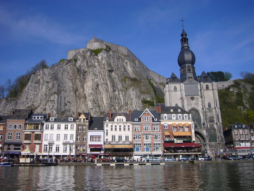 The city center with the Notre Dame de Dinant church, the Citadel of Dinant and the Meuse river, viewed from the tour boat