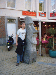 Tim with a Moai statue in front of the Les Amourettes restaurant at the Place Saint-Nicolas square