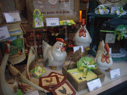 Chicken statuettes and other items in the window of a shop south of the city center