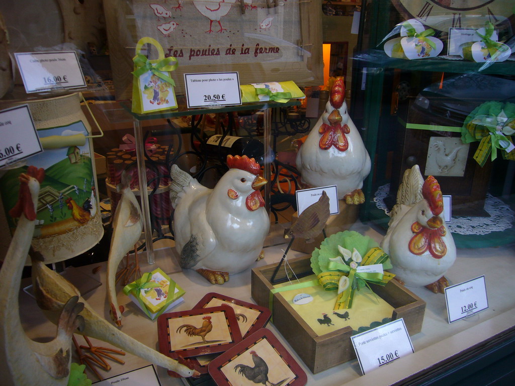 Chicken statuettes and other items in the window of a shop south of the city center