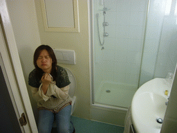 Miaomiao on the toilet of our room at the Hotel Ibis Dinant