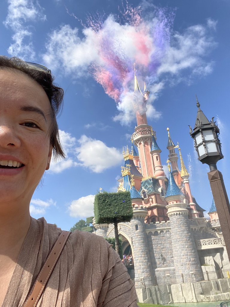 Miaomiao in front of Sleeping Beauty`s Castle at Fantasyland and fireworks at Disneyland Park