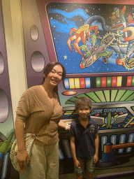 Miaomiao and Max with a wall painting at the queue of the Buzz Lightyear Laser Blast attraction at Discoveryland at Disneyland Park