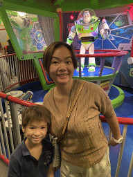 Miaomiao and Max with a statue of Buzz Lightyear at the queue of the Buzz Lightyear Laser Blast attraction at Discoveryland at Disneyland Park