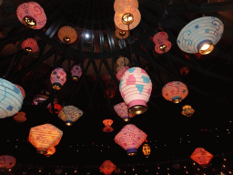 Paper lanterns on the ceiling of the Mad Hatter`s Tea Cups attraction at Fantasyland at Disneyland Park, by night