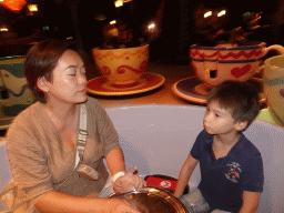 Miaomiao and Max at the Mad Hatter`s Tea Cups attraction at Fantasyland at Disneyland Park, by night