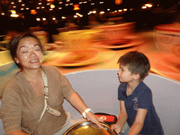 Miaomiao and Max at the Mad Hatter`s Tea Cups attraction at Fantasyland at Disneyland Park, by night