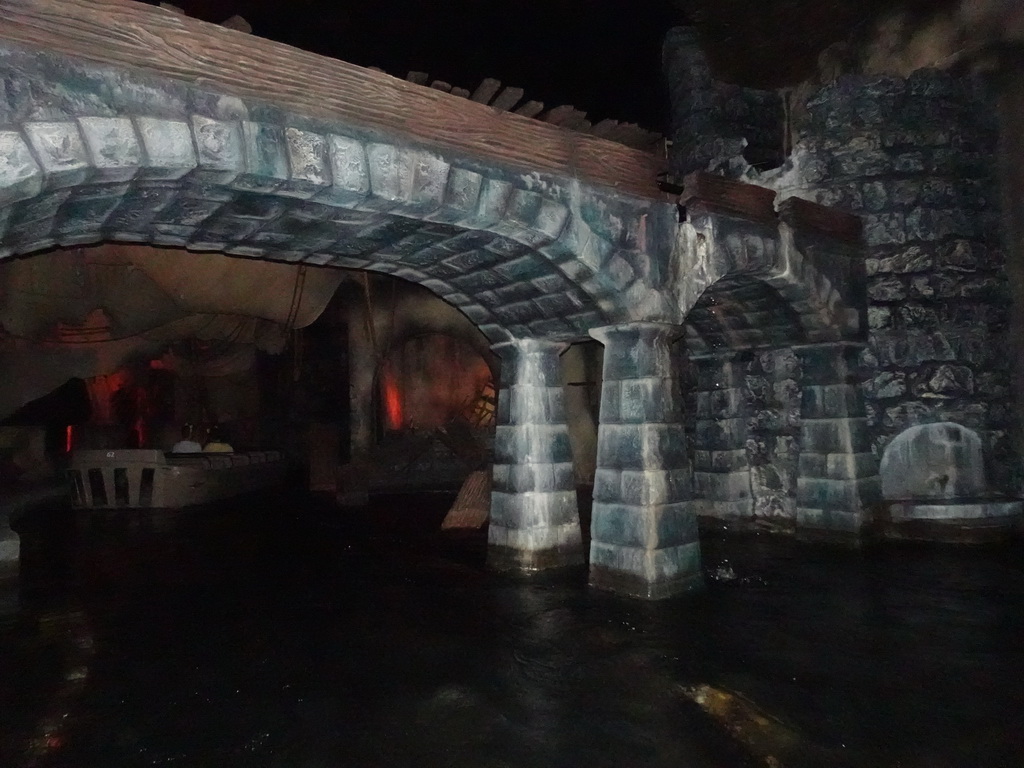 Tower, bridge and boat at the Pirates of the Caribbean attraction at Adventureland at Disneyland Park, viewed from our boat, by night